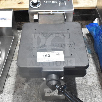 Sephra SERTWFL01 commercial countertop waffle maker, black, 110-120 volts, with temperature control dial and caution label.