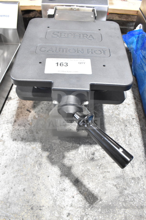 Sephra SERTWFL01 commercial waffle maker, 110-120V, with "Caution Hot" label, showing sturdy handle, in good condition.