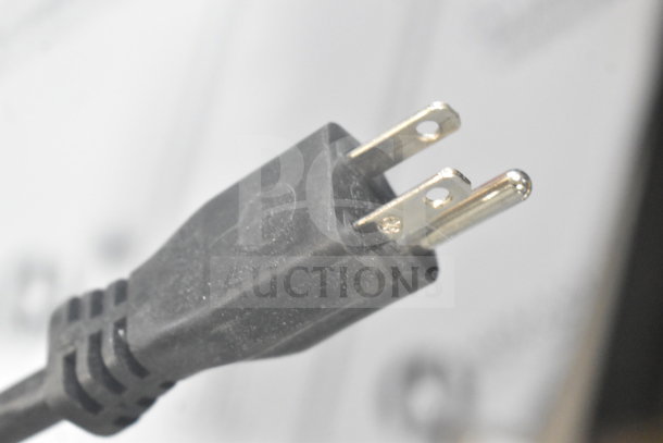 Close-up of a 120-volt power plug for a Cadco 2025 OV-013 XAF013-US convection oven, missing its door.