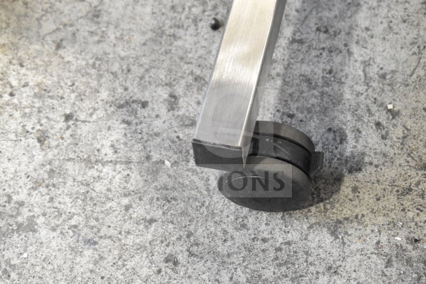 Close-up of wheel on Enercon Super Seal Max Induction Cap Sealer, Model LM5431-T07, showing metal frame and durable caster.