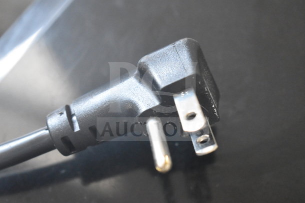 Close-up of the plug for an Aquaverse A6500 water dispenser, showing its three-prong design.