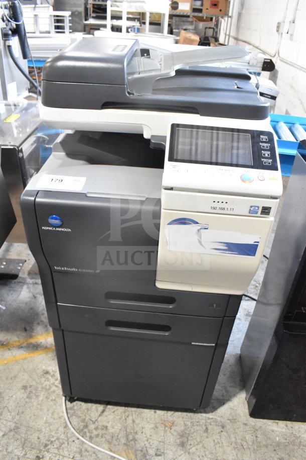 Konica Minolta Bizhub C3350 floor copier, printer, scanner in working condition. Features touchscreen, labeled IP address.