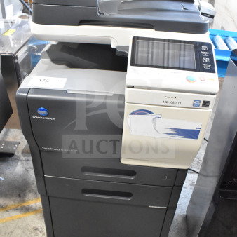 Konica Minolta Bizhub C3350 floor copier, printer, scanner in working condition. Features touchscreen, labeled IP address.