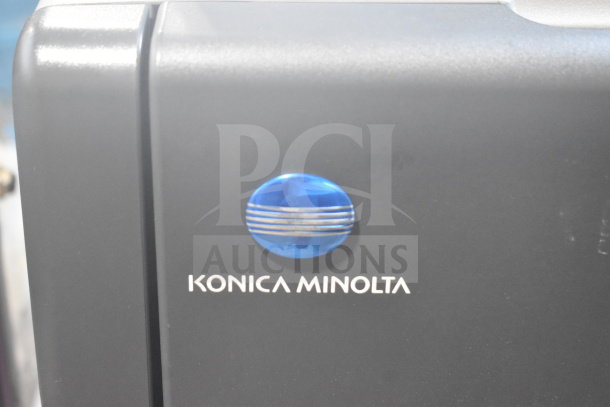 Konica Minolta logo on Bizhub C3350 scanner copier printer, showing brand emblem on a gray surface.