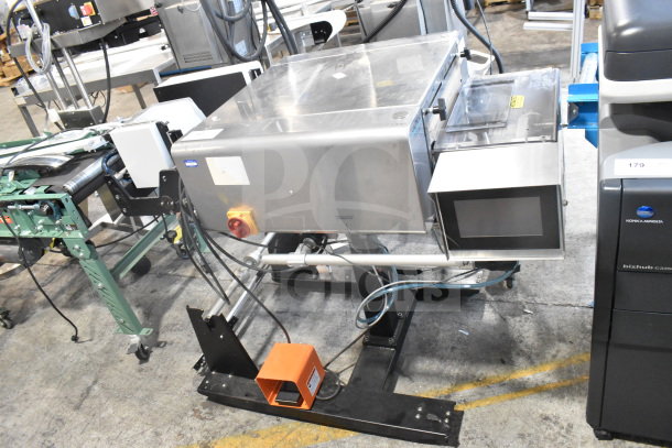 Advanced Poly Packaging T-1000 poly bagger, stainless steel, 117/220 volts, with control panel, integrated conveyor system.