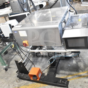 Advanced Poly Packaging T-1000 poly bagger, stainless steel, 117/220 volts, with control panel, integrated conveyor system.