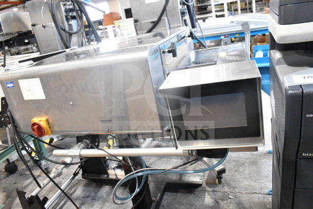 Advanced Poly Packaging T-1000 Bagger, used, 117/220 volts, touchscreen interface, stainless steel body, visible connection ports.