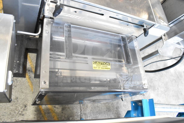 Advanced Poly Packaging T-1000 Bagger, clear panel with caution label, 117/220 volts, sturdy metal construction.