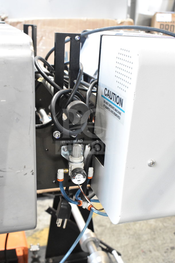 Advanced Poly Packaging T-1000 poly bagger, compact design, visible wiring, labeled controls, 117/220 volts, caution label.