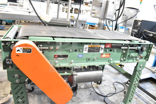 Roach floor style conveyor, 115V, 1 phase. Green metal frame, operating warnings, Roach branding visible.