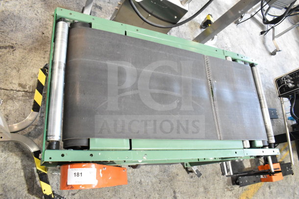 Roach floor style conveyor, 115 volts, 1 phase, green frame, rollers visible. Auction tag labeled "181".