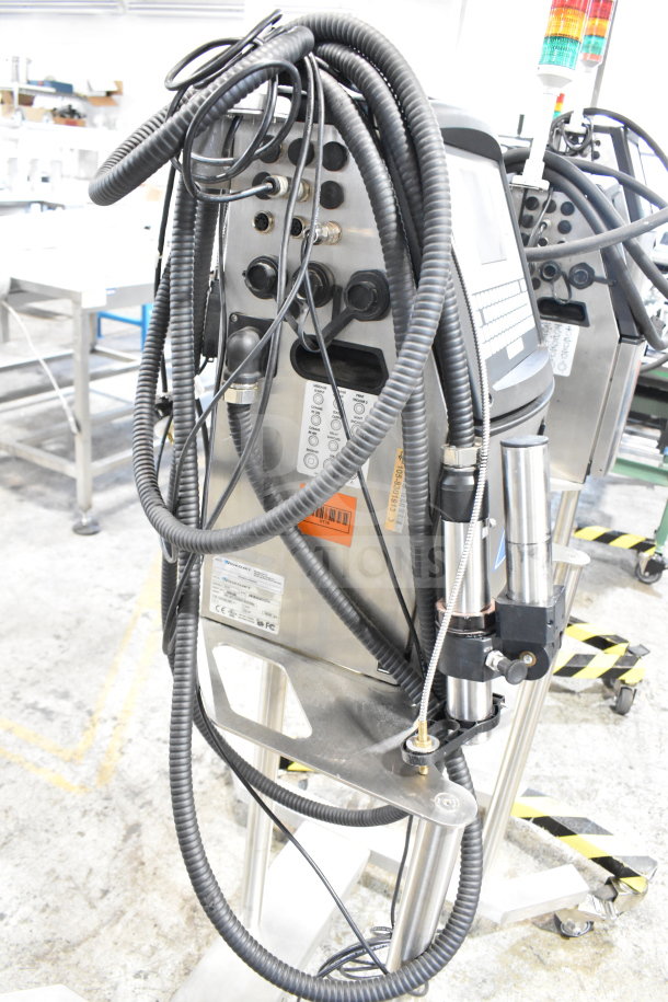 Videojet 1610 floor-style inkjet coding machine, stainless steel, multiple cables, visible control panel, good condition.