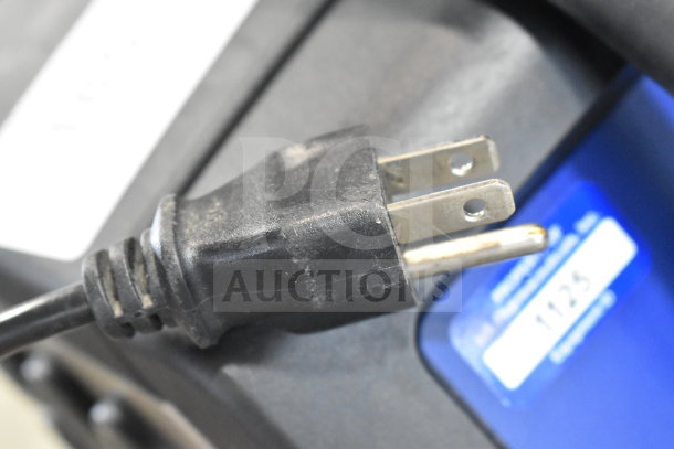 Videojet 1220 inkjet coding machine plug, showing 100-120/200-240V compatibility tag. Floor style, single-phase unit.