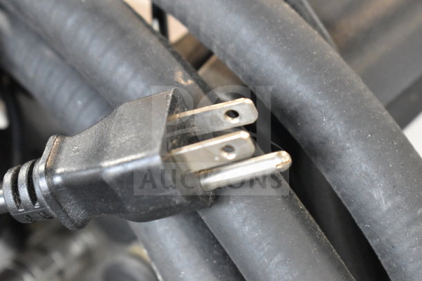 Close-up of power plug for Videojet 1620 Inkjet Coding Machine, showing standard prongs and durable cable condition.