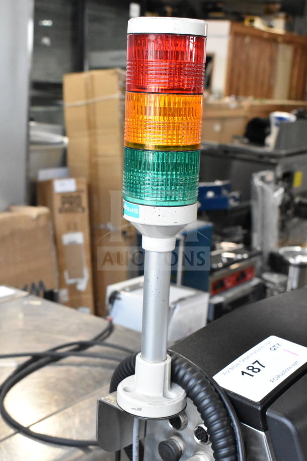 Videojet 1610 Inkjet Coding Machine with signal tower, showing RoHS compliance label. Model for versatile industrial use.