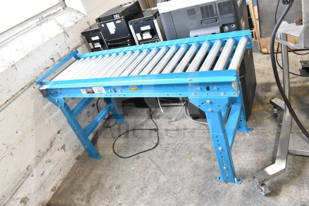 Hytrol Floor Style Roller Conveyor in blue, excellent condition, features adjustable legs and durable rollers. Model 1258 visible.