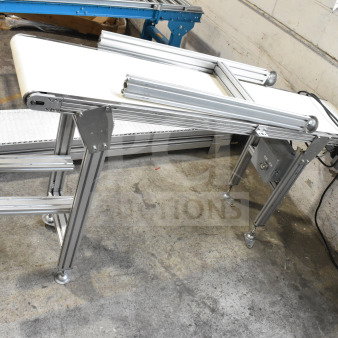 MiSumi floor-style conveyor, 115V, 1 phase, in excellent condition. Features aluminum frame and white belt.