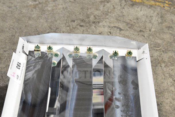Howard M032817 light fixture with reflective panels, white frame, and electrical sockets. Auction tag visible with number 193.