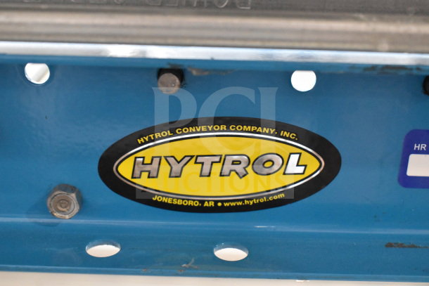 Hytrol Floor Style Roller Conveyor with company logo. Features sturdy construction and visible blue frame in good condition.