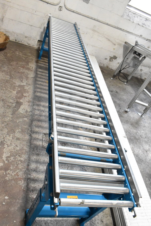 Hytrol floor-style roller conveyor, metal rollers, blue frame, in good condition, designed for industrial material handling.
