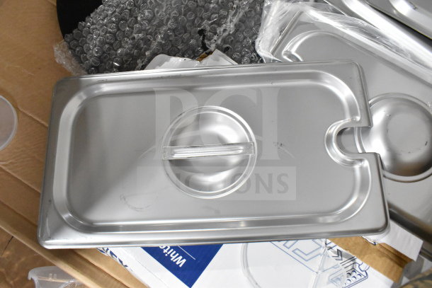 Silver drop-in bin lid among mixed auction items, includes Crathco hoppers, coffee filters, knives, exit signs, and sheet pans.