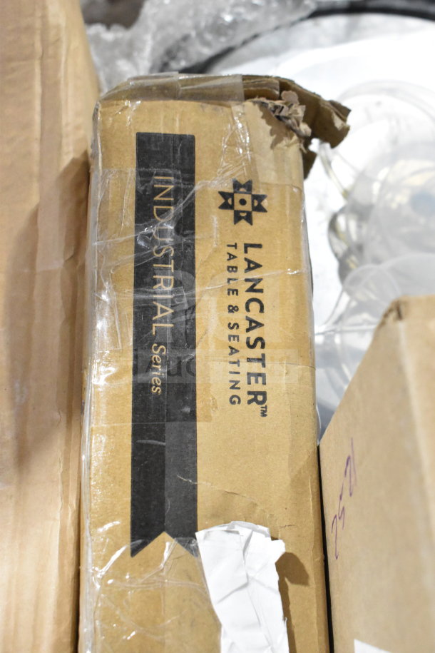 Lancaster Table & Seating Industrial Series box, sealed, slightly damaged, containing various auction items.