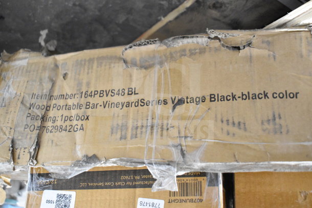 Cardboard box labeled with item number 164PBVS48 BL, containing a wood portable bar from Vineyard Series, vintage black. Box shows wear.