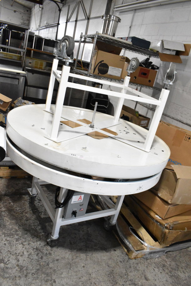 2 American Design ADP-48-PC rotary tables on casters, 115 volts, 1 phase, shown in storage area.