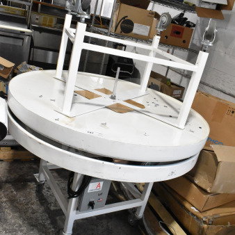 2 American Design ADP-48-PC rotary tables on casters, 115 volts, 1 phase, shown in storage area.