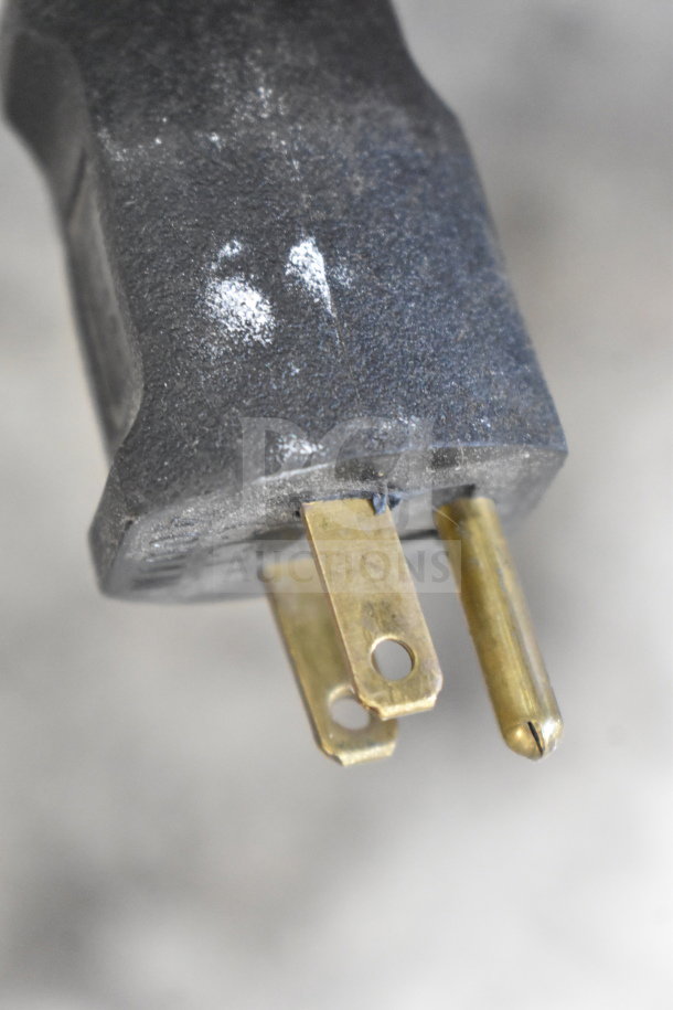 Close-up of a plug for an American Design ADP-48-PC rotary table, 115 volts, in good condition. Commercial casters included.