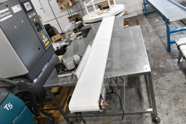 Dorner 32MTEM12 floor conveyor with table, 115 volts, 1 phase. Features white belt and stainless steel frame. Excellent condition.