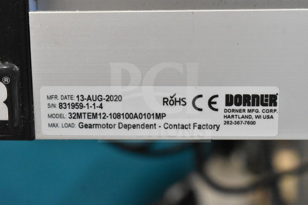 Dorner 32MTEM12 floor conveyor label showing model, serial number, manufacture date, and factory contact info.