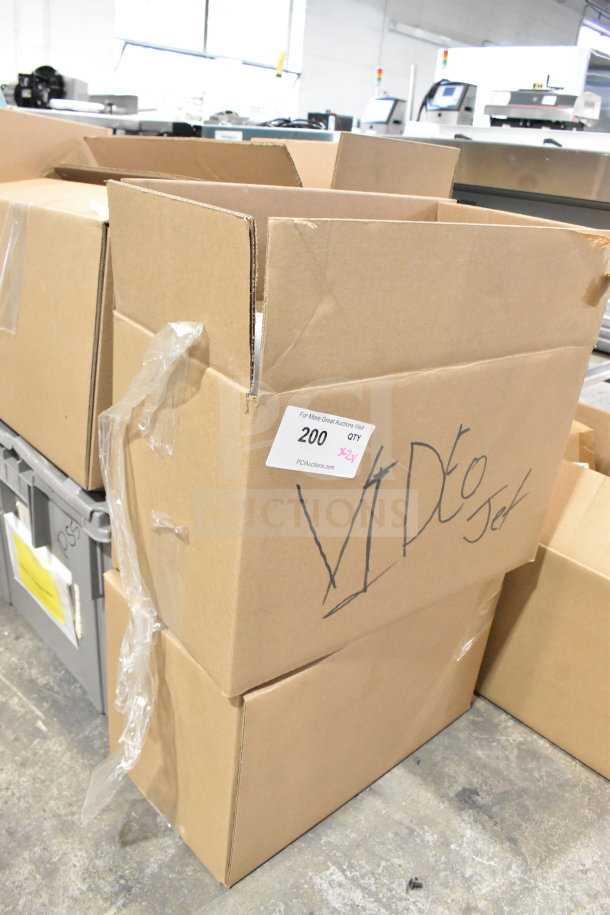 Cardboard boxes labeled "Via Do Jet" with auction tag, containing wash station kit, 25 way I/O breakout cable, fiber optic light guide.