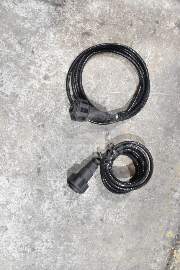 Two coiled black cables with connectors, likely included in a 2-box auction set with a wash station kit and fiber optic light guide.