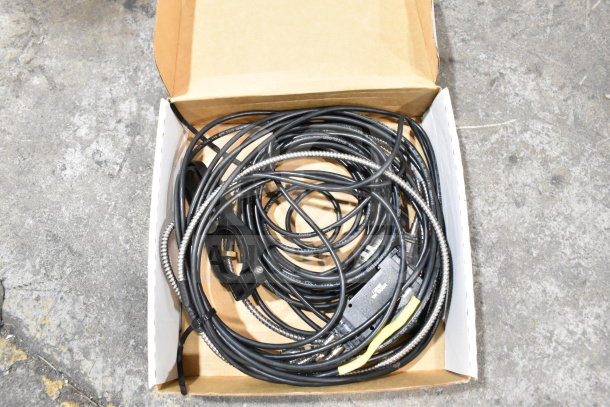 Box containing various cables, including a 25-way I/O breakout cable and fiber optic light guide, for auction. Includes wash station kit.
