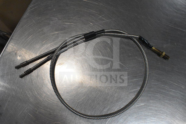 Fiber optic light guide with metal connector ends, part of auction lot including wash station kit and breakout cable, good condition.