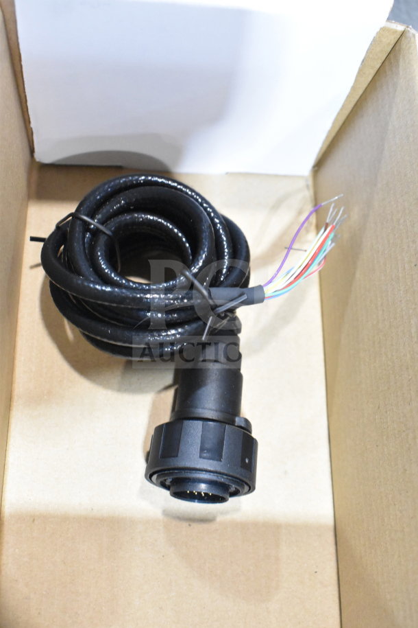 Box containing a 25-way I/O breakout cable with connected black wiring. Condition appears good.