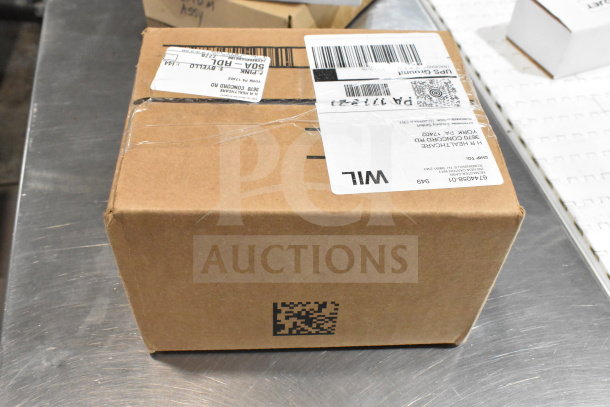 Cardboard box with shipping labels on a metal surface, containing various VideoJet items for auction.