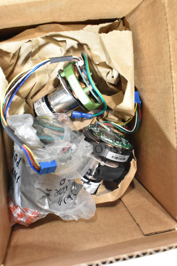 Box containing various VideoJet components including label sensor and printhead, new condition, with wires and packaging visible.