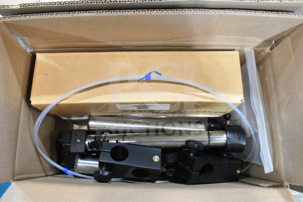 Two boxes containing various items including cables, mounting plates, VideoJet nozzle bypass manifold kit, and more.