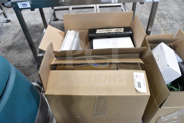 Two boxes containing cables, mounting plates, and a VideoJet Nozzle Bypass Manifold Kit, labeled for auction.