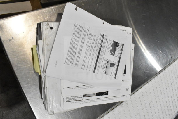Two boxes contain mixed items; papers, manuals, including cables, mounting plates, and a VideoJet Nozzle Bypass Manifold Kit.
