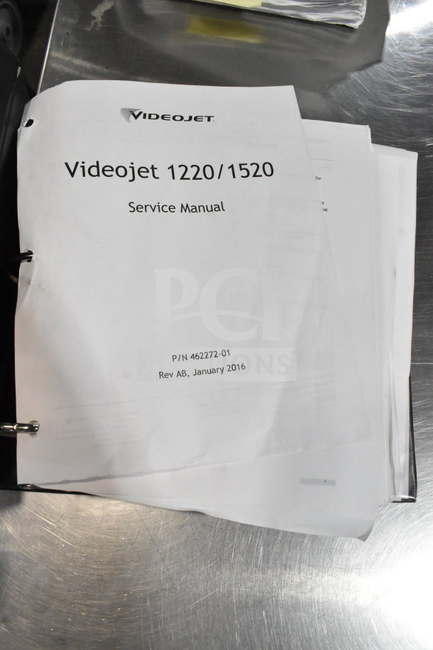 Image of a VideoJet 1220/1520 service manual binder on a metal surface, labeled with P/N 462272-01, dated January 2016.