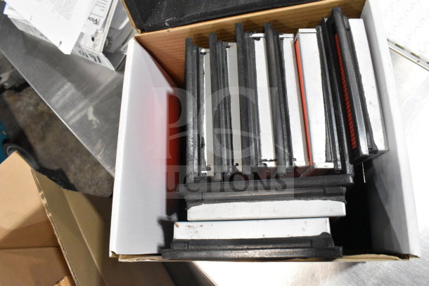 Two boxes containing various items such as cables, mounting plates, and a VideoJet Nozzle Bypass Manifold Kit.