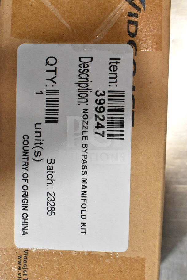 Two boxes containing cables, mounting plates, and a VideoJet Nozzle Bypass Manifold Kit, labeled item 399247, batch 23285.
