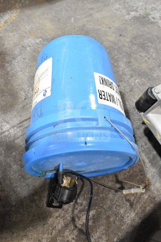 Blue water bucket with attached filter, labeled "All One Money! Do Not Drink!" Used condition, visible wiring and connectors.