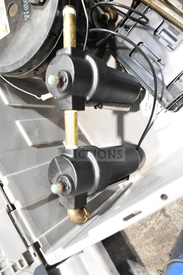 Bin containing water buckets and a water filter system with visible wiring and connectors. Good condition.