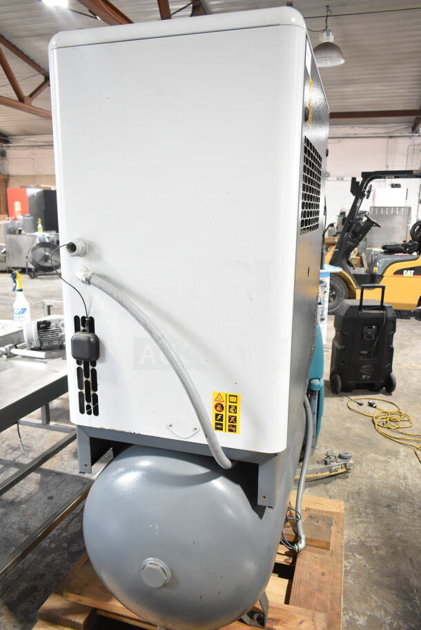 Atlas Copco GA11VSD rotary screw air compressor, model GA11VSD, in good condition, white casing, visible warning labels.