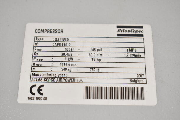 Atlas Copco GA11VSD compressor label showing model details, power, pressure, flow rate, and manufacturing info.