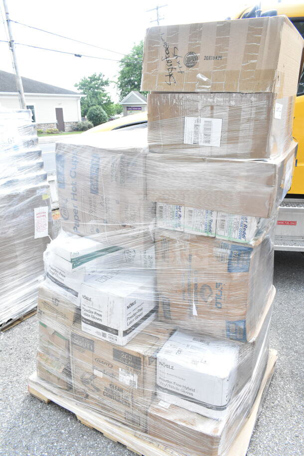 Sealed pallet with 26 assorted scratch and dent items, including napkins, paper plates, lids, and gloves.